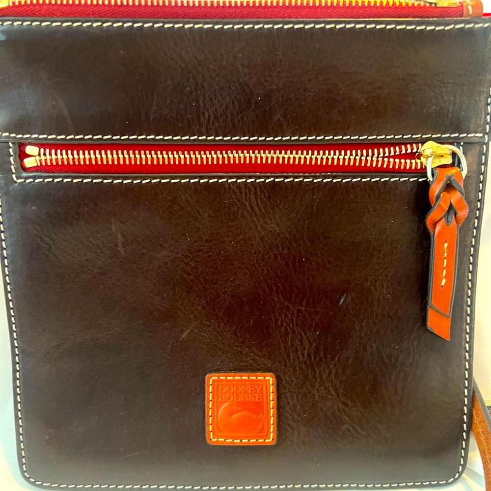 Dooney & Bourke slim crossbody in dark brown, tan trim and red interior
